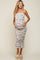 woman wearing a floral maternity dress with ruffle details and holding her baby bump