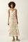 woman wearing a floral maxi dress with spaghetti straps, featuring a tiered hem and a fitted waist