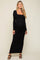 woman wearing a black ribbed long sleeve maternity dress with a square neckline and a visible baby bump