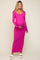 woman wearing a pink long sleeve maternity dress and holding her baby bump