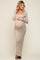 woman wearing a beige long sleeve maternity dress, showcasing her baby bump