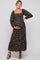 woman wearing a black floral maternity maxi dress with long puff sleeves and holding her baby bump