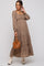 woman wearing a brown floral maternity maxi dress with long sleeves and a baby bump, holding a brown handbag