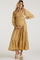 woman wearing a yellow floral maternity maxi dress with smocked bodice and tiered skirt, holding her baby bump