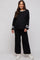 woman wearing a black maternity loungewear set with white striped details and a visible baby bump