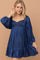 woman wearing a navy blue short puff sleeve dress with a square neckline and ruffled hem
