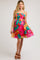 woman wearing a bright floral maternity dress with thin straps and a flared skirt