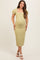 woman wearing a light green short sleeve maternity dress with a fitted silhouette and puffed sleeves, showing her baby bump