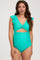 woman wearing a bright teal maternity swimsuit with ruffle sleeves and a cut-out design, highlighting her baby bump