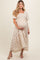 woman wearing a floral print maternity maxi dress with puff sleeves and holding her baby bump