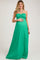woman wearing a green halter neck maternity maxi dress and holding her baby bump