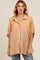 woman wearing a light orange striped maternity button-up shirt with short sleeves and relaxed fit