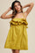 woman wearing a yellow ruffled mini dress with adjustable straps and a gathered waist