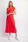 woman wearing a red short sleeve maxi dress paired with white sneakers