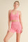 woman wearing a pink ribbed sports bra and matching high-waisted shorts