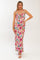 woman wearing a pink floral maxi dress with spaghetti straps and a fitted bodice
