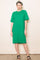 woman wearing a bright green short sleeve oversized dress with a pocket and side slits