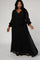 plus size woman wearing a long sleeve black wrap maxi dress with a belted waist