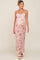 pregnant woman wearing a pink floral maternity maxi dress with spaghetti straps and white sandals