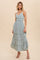 woman wearing a sage green tiered maxi dress with spaghetti straps and ruffled waist detail