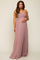 woman wearing a dusty rose strapless maternity gown with ruched details and holding her baby bump