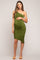 woman wearing a dark green one-shoulder maternity dress with a visible baby bump