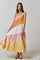 woman wearing a colorful tiered maxi dress with pink, orange, white, and peach stripes