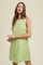woman wearing a sleeveless light green shift dress with a relaxed fit