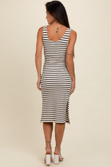 woman wearing a black and white striped sleeveless midi dress with side slit, seen from the back