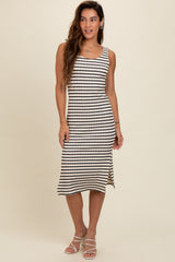 woman wearing a striped midi tank dress in black and cream with a fitted silhouette and a flared hem