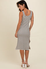 woman wearing a striped knee-length dress with a scoop back and fitted silhouette, shown from the back