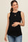 woman wearing a black maternity top with ruffle details and a visible baby bump, paired with light blue jeans