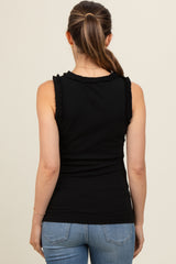 woman wearing a black maternity tank top with ruffle details and light blue jeans, showing her back