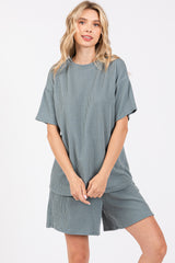 woman wearing a teal striped short sleeve loungewear set with a relaxed fit