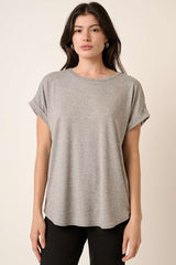 woman wearing a gray short sleeve t-shirt with rolled cuffs and a relaxed fit