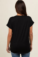 woman wearing a black short sleeve maternity top, viewed from the back, paired with light blue jeans
