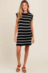 woman wearing a black and white striped maternity dress with short sleeves and a fitted silhouette