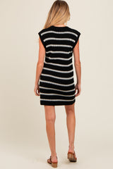woman wearing a black and white striped maternity dress with cap sleeves, showing a fitted silhouette