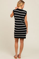 woman wearing a sleeveless black and white striped knit dress, showing the back view
