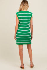 woman wearing a green and white striped sleeveless maternity dress, showing a baby bump from behind