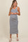 woman wearing a navy and white striped maternity dress, showing her baby bump, with a mid-length cut