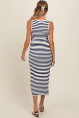 woman wearing a navy and white striped maternity maxi dress, showing the back view and extending to mid-calf