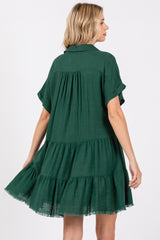woman wearing a green short sleeve tiered dress with a relaxed fit and frayed hem details