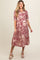 woman wearing a red and cream floral maternity dress with short sleeves and a flowy skirt, showcasing her baby bump