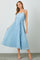 woman wearing a light blue pleated maxi dress with thin straps and a drawstring waist