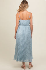 woman wearing a light blue maternity maxi dress with pleated details and thin straps, showing the back view