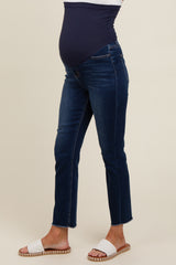 woman wearing a dark blue pair of maternity jeans with a supportive waistband and frayed hem