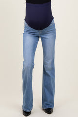 woman wearing light blue maternity flared jeans with a dark blue over-the-bump panel