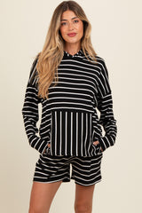 woman wearing a black and white striped maternity lounge set with a hoodie and shorts