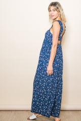 woman wearing a blue floral maxi dress with a back cutout and ruffled straps